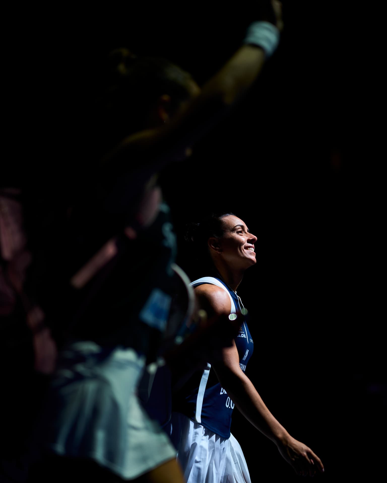 Padel player smiling under arena lights